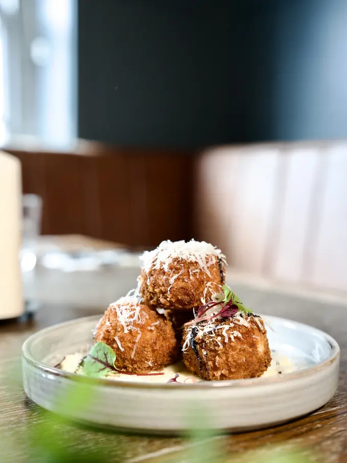 Arancini plated with a citrus mayo