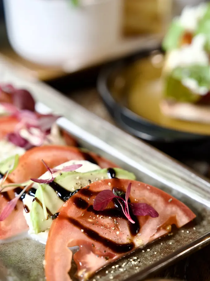A dressed salad plated at the pass
