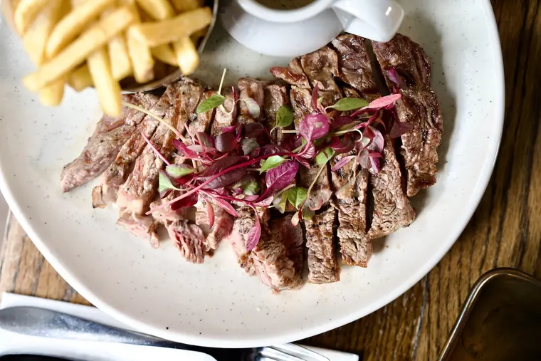 Steak frites with skinny fries and peppercorn sauce